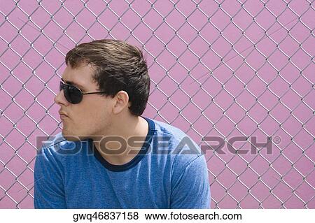 Stock Photo - Close-up of a young man wearing sunglasses. Fotosearch