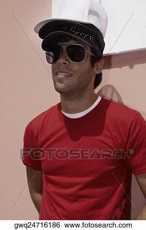 Close-up of a young man wearing three caps View Large Photo Image Stock Photograph - Close-up of a young man wearing three caps. Fotosearch