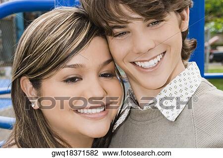 Close-up of a young woman and a teenage boy smiling View Large Photo Image Stock Image - Close-up of a young woman and a teenage boy smiling. Fotosearch
