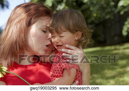 Close-up of a young woman consoling her daughter View Large Photo Image Stock Photography - Close-up of a young woman consoling her daughter. Fotosearch