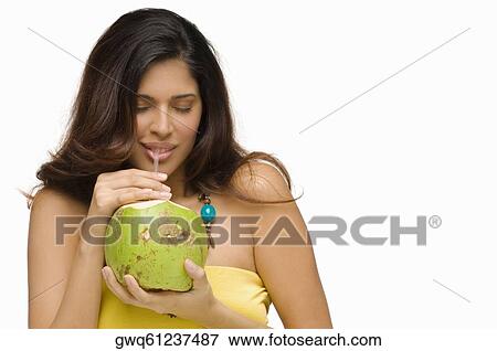 Close-up of a young woman drinking coconut milk View Large Photo Image Stock Photo - Close-up of a young woman drinking coconut milk. Fotosearch
