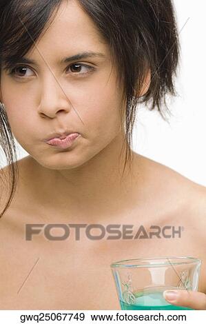 Stock Photo - Close-up of a young woman gargling. Fotosearch