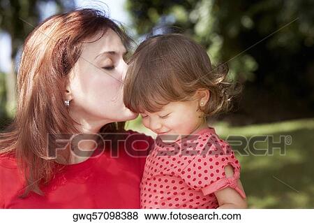 Stock Photo - Close-up of a young woman loving her daughter. Fotosearch
