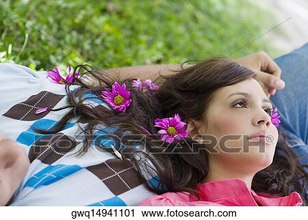 Stock Image - Close-up of a young woman lying on a young man. Fotosearch