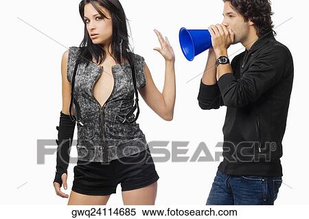 Close-up of a young woman stopping a young man to blow a megaphone View Large Photo Image Stock Photography - Close-up of a young woman stopping a young man to blow a megaphone. Fotosearch
