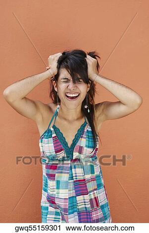 Close-up of a young woman suffering from a headache View Large Photo Image Stock Image - Close-up of a young woman suffering from a headache. Fotosearch