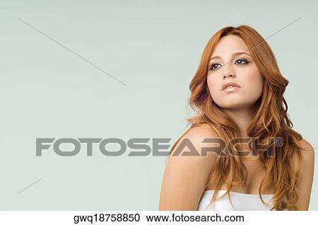 Stock Image - Close-up of a young woman thinking. Fotosearch