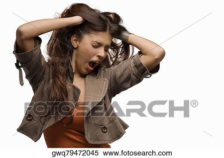 Stock Photography - Close-up of a young woman yawning and her hands in her hair. Fotosearch
