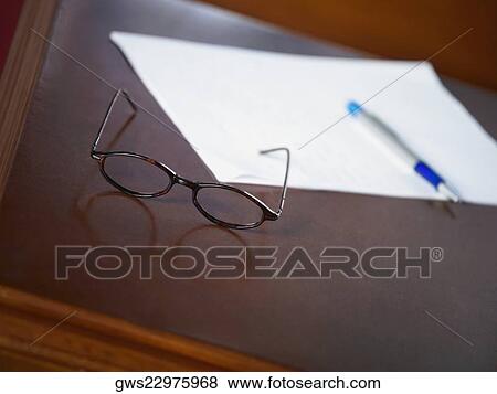 Stock Photo - Close-up of eyeglasses on a table. Fotosearch