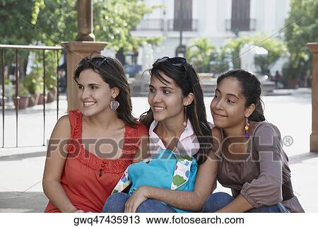 Close-up of three young women sitting and smiling View Large Photo Image Stock Image - Close-up of three young women sitting and smiling. Fotosearch