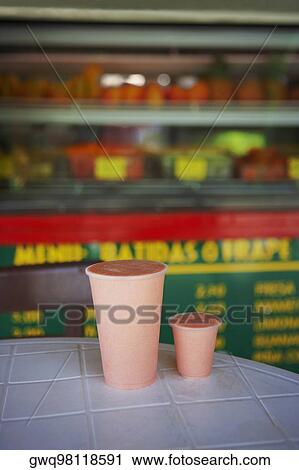 Close-up of two glasses of juice on a table at a juice bar View Large Photo Image Stock Image - Close-up of two glasses of juice on a table at a juice bar. Fotosearch