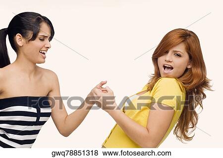 Close-up of two young women playing together View Large Photo Image Stock Photo - Close-up of two young women playing together. Fotosearch