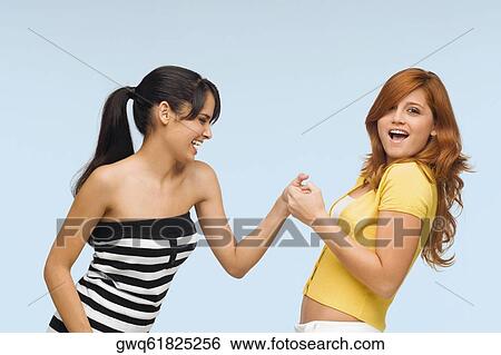 Stock Photograph - Close-up of two young women playing together. Fotosearch