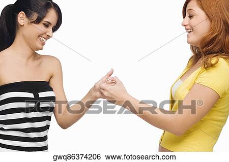 Stock Photograph - Close-up of two young women playing together. Fotosearch