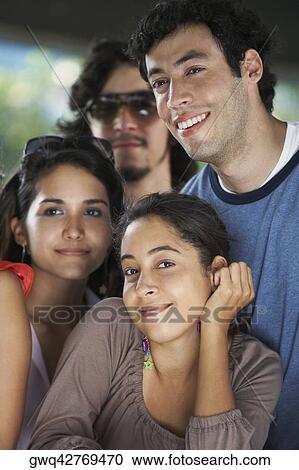 Close-up of two young women smiling with two young men View Large Photo Image Stock Image - Close-up of two young women smiling with two young men. Fotosearch