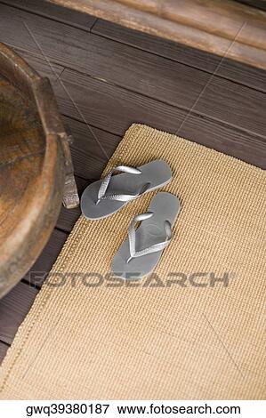 Stock Photo - Flip flops on rug. Fotosearch
