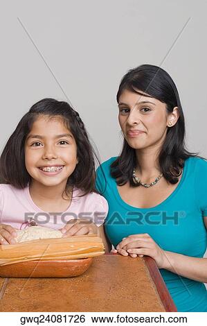 Girl preparing bread with her sister in the kitchen View Large Photo Image Stock Photograph - Girl preparing bread with her sister in the kitchen. Fotosearch
