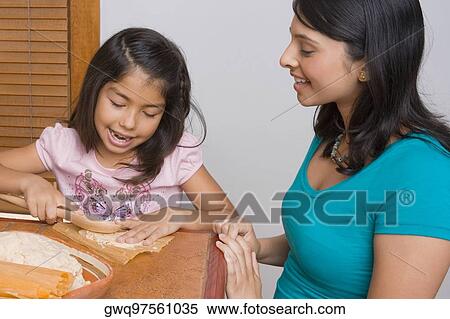 Girl preparing bread with her sister in the kitchen View Large Photo Image Stock Photography - Girl preparing bread with her sister in the kitchen. Fotosearch