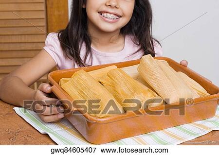 Girl smiling with a tray of breads in the kitchen View Large Photo Image Stock Photo - Girl smiling with a tray of breads in the kitchen. Fotosearch