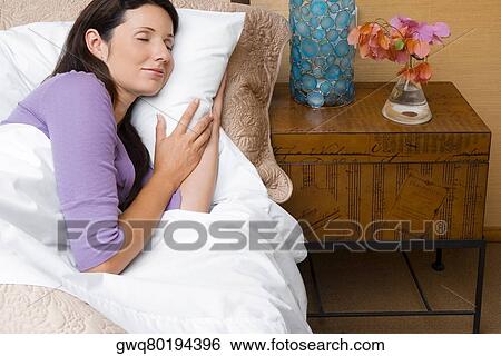 High angle view of a mid adult woman sleeping on the bed View Large Photo Image Stock Photograph - High angle view of a mid adult woman sleeping on the bed. Fotosearch