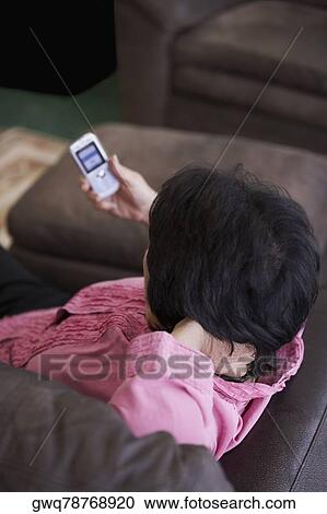 High angle view of a woman holding a mobile phone View Large Photo Image Stock Image - High angle view of a woman holding a mobile phone. Fotosearch