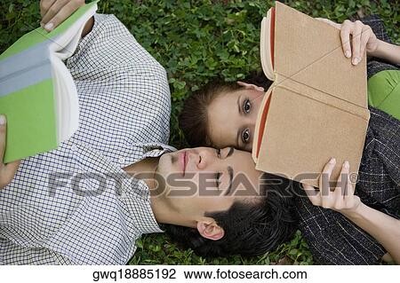 High angle view of a young couple holding books View Large Photo Image Stock Image - High angle view of a young couple holding books. Fotosearch