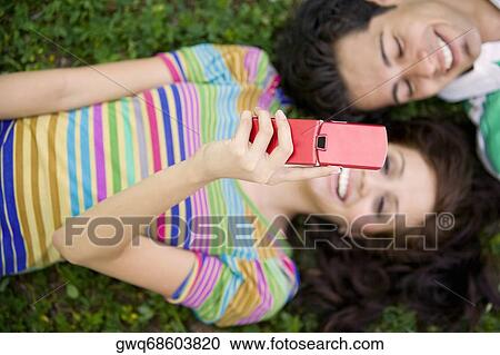 Stock Image - High angle view of a young couple smiling together. Fotosearch