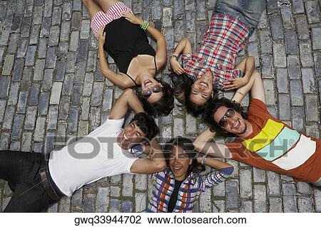 High angle view of three young women with two young men lying on cobblestone and smiling, Old San Juan, San Juan, Puerto Rico View Large Photo Image Stock Image - High angle view of three young women with two young men lying on cobblestone and smiling, Old San Juan, San Juan, Puerto Rico. Fotosearch