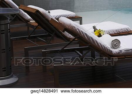 Lounge chairs at the poolside View Large Photo Image Stock Image - Lounge chairs at the poolside. Fotosearch