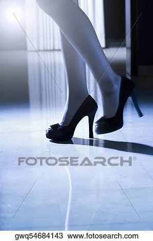 Low section view of a woman wearing high heels View Large Photo Image Stock Image - Low section view of a woman wearing high heels. Fotosearch