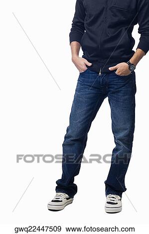 Low section view of a young man standing with his hands in his pockets View Large Photo Image Stock Photo - Low section view of a young man standing with his hands in his pockets. Fotosearch
