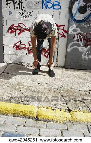 Man exercising in front of a wall View Large Photo Image Stock Image - Man exercising in front of a wall. Fotosearch