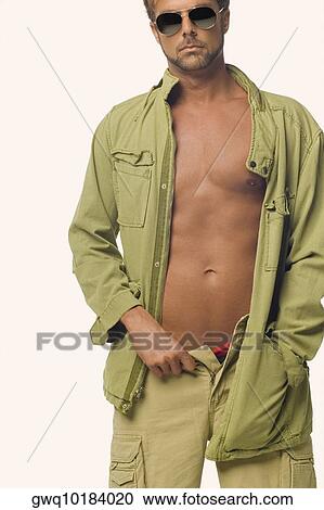 Mid adult man standing with his one hand in his pocket View Large Photo Image Stock Image - Mid adult man standing with his one hand in his pocket. Fotosearch