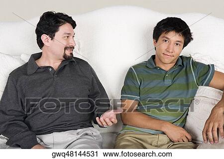 Mid adult man talking to his son View Large Photo Image Stock Image - Mid adult man talking to his son. Fotosearch