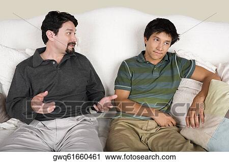 Mid adult man talking to his son View Large Photo Image Stock Image - Mid adult man talking to his son. Fotosearch