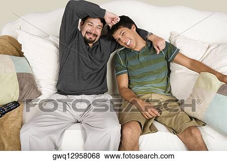Mid adult man with his arm around his son View Large Photo Image Stock Photo - Mid adult man with his arm around his son. Fotosearch