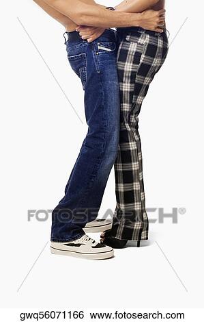 Mid section view of a young couple standing together View Large Photo Image Stock Photograph - Mid section view of a young couple standing together. Fotosearch
