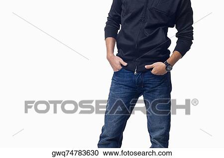 Mid section view of a young man standing with his hands in his pockets View Large Photo Image Stock Image - Mid section view of a young man standing with his hands in his pockets. Fotosearch