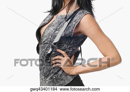 Mid section view of a young woman with her hand on her hip View Large Photo Image Picture - Mid section view of a young woman with her hand on her hip. Fotosearch
