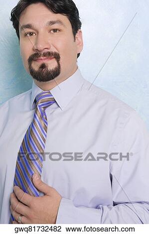 Stock Image - Portrait of a businessman smirking. Fotosearch