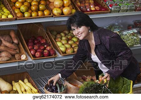 Portrait of a mature woman shopping in a grocery store View Large Photo Image Stock Image - Portrait of a mature woman shopping in a grocery store. Fotosearch