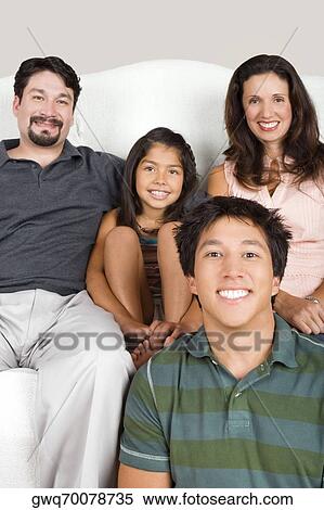 Stock Photography - Portrait of a mid adult couple with their son and daughter. Fotosearch