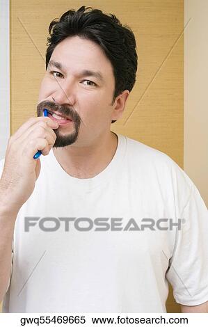 Portrait of a mid adult man brushing his teeth View Large Photo Image Stock Photography - Portrait of a mid adult man brushing his teeth. Fotosearch