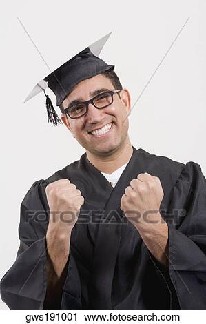 Stock Image - Portrait of a mid adult man clenching his fists and smiling. Fotosearch