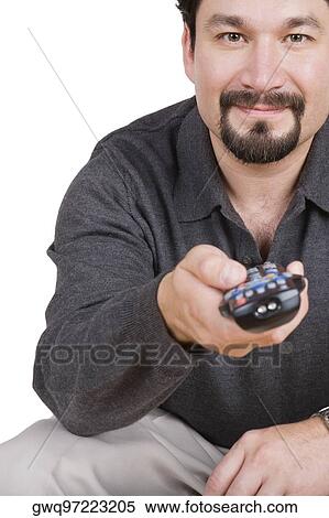 Portrait of a mid adult man holding a remote control and smirking View Large Photo Image Stock Photography - Portrait of a mid adult man holding a remote control and smirking. Fotosearch