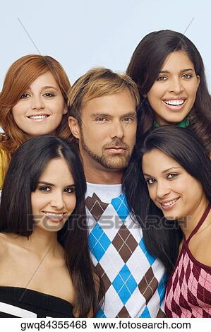 Stock Photo - Portrait of a mid adult man posing with four young women. Fotosearch