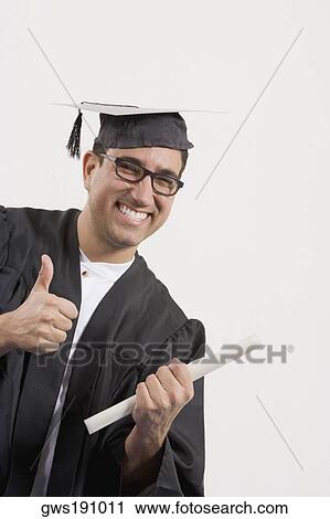 Portrait of a mid adult man showing a thumbs up sign and holding a diploma View Large Photo Image Stock Image - Portrait of a mid adult man showing a thumbs up sign and holding a diploma. Fotosearch