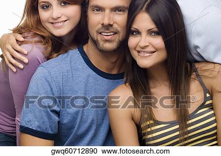 Portrait of a mid adult man smiling with two young women View Large Photo Image Stock Image - Portrait of a mid adult man smiling with two young women. Fotosearch
