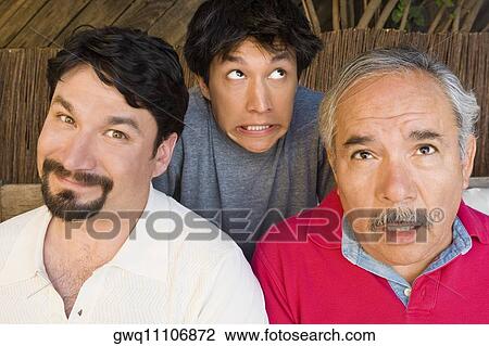 Portrait of a mid adult man smirking with his father and son making their faces View Large Photo Image Stock Image - Portrait of a mid adult man smirking with his father and son making their faces. Fotosearch