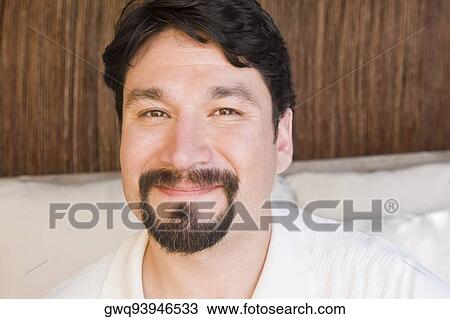 Portrait of a mid adult man smirking View Large Photo Image Stock Image - Portrait of a mid adult man smirking. Fotosearch